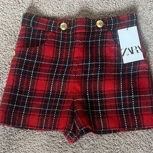 Red, Black, and White Plaid Shorts with Gold Embellishments